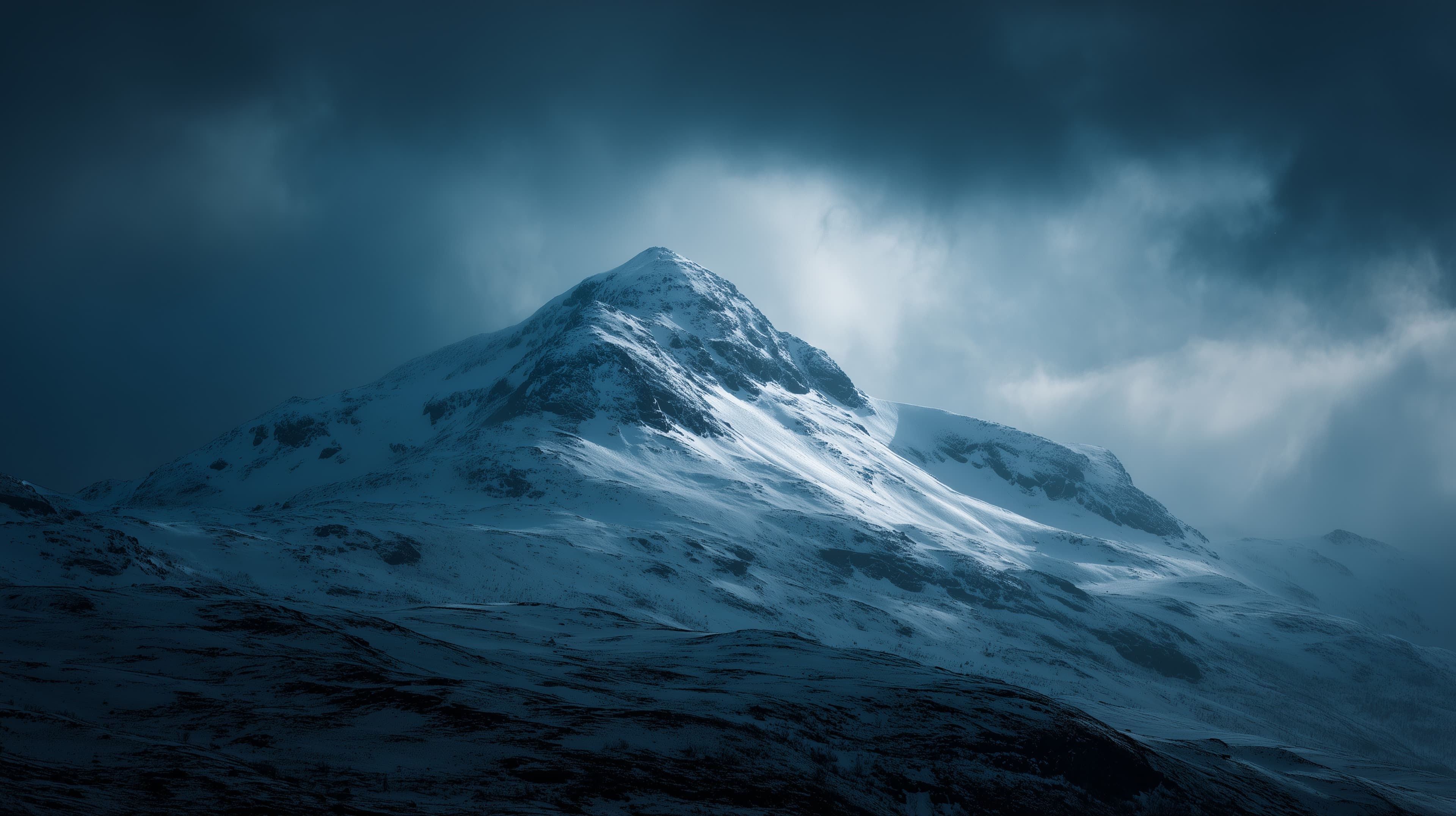 Atmospheric Snowy Mountain Peak in Moody Blue Winter Scene - High Resolution snow Wallpaper for Mobile and Desktop
