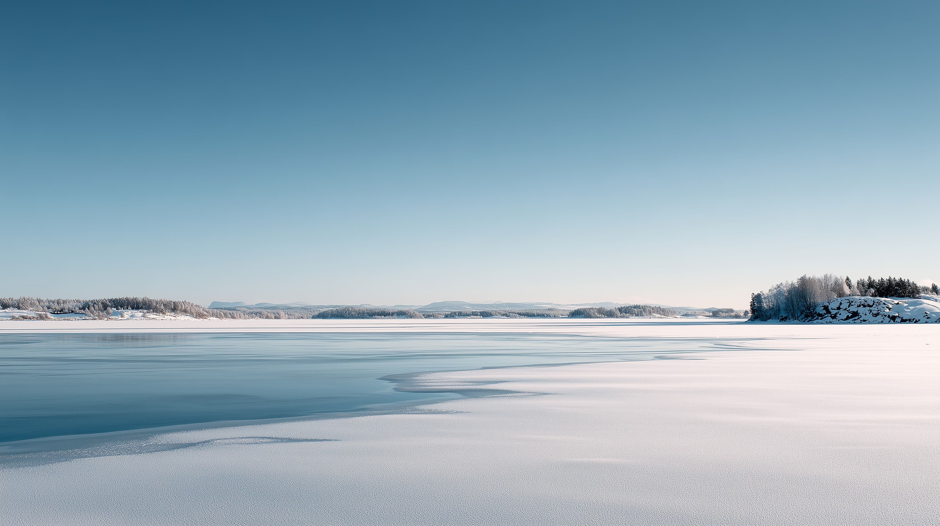 Tranquil Winter Landscape over a Frozen Lake under Blue Sky - High Resolution blue-sky Wallpaper for Mobile and Desktop