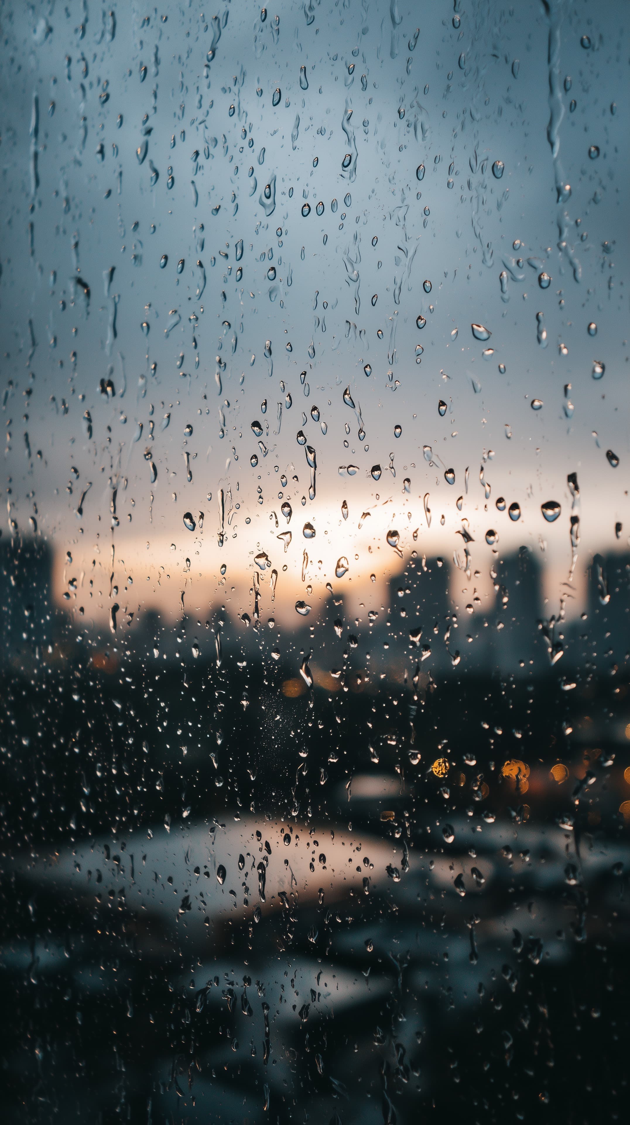 Rainy Window Wallpaper: City Skyline at Dusk with Raindrops - High Resolution bokeh-lights Wallpaper for Mobile and Desktop